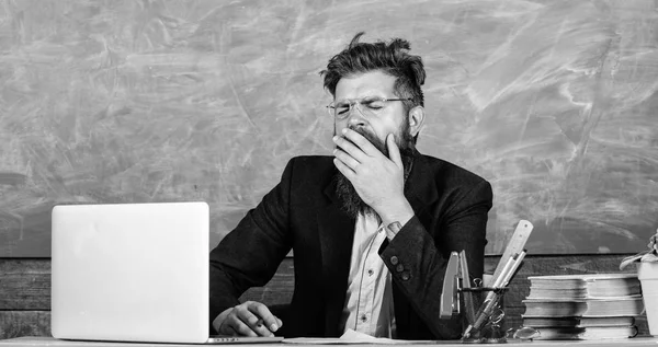 Educators more stressed at work than average people. High level fatigue. Exhausting work in school causes fatigue. Educator bearded man yawning face tired at work. Life of teacher full of stress