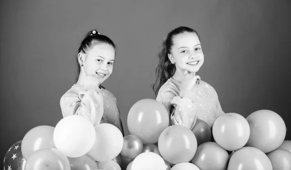 Carefree childhood. Sisters organize home party. Greeting concept. Having fun concept. Balloon theme party. Girls friends near air balloons. Start party. Birthday party. International childrens day