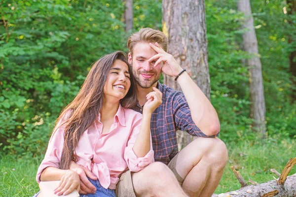 Couple spend time outdoors on sunny day. Youth on picnic or hike relaxing and having fun. Pleasant weekend. Couple tourists rest forest. Couple or family having great time relaxing with book