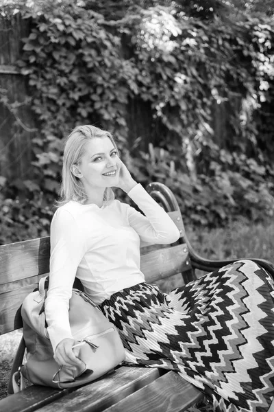 Ways to give yourself break and enjoy leisure. Peace and tranquility. Why you deserve break. Girl sit bench relaxing in shadow, green nature background. Woman blonde take break relaxing in park