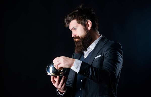 Serving and presentation. Elite luxurious. Secret under cloche. Exclusive food hidden cloche. What is under cloche. Waiter luxury restaurant. Man well groomed gentleman formal suit hold little cloche