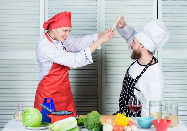 Cooking with your spouse can strengthen relationships. Couple compete in culinary arts. Woman and bearded man culinary partners. Reasons why couples cooking together. Ultimate cooking challenge