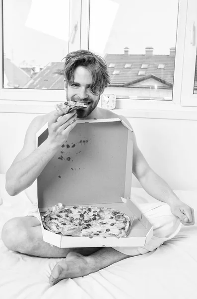 Man bearded handsome eat pizza. Man eat pizza breakfast. Guy naked covered pizza box sit bed bedroom offer you join him. Sexy courier delivers gastronomic satisfaction. Gastronomic satisfaction