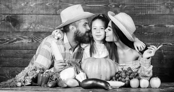 Grown with love. Family rustic style farmers at market with vegetables fruits and greenery. Parents and daughter harvest festival. Family farm concept. Family farmers with harvest wooden background — Stock Photo, Image