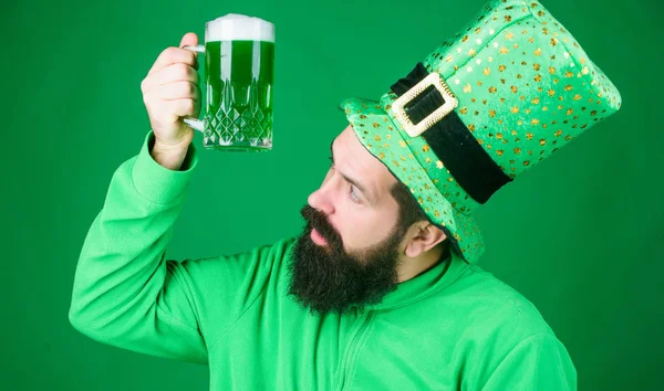Irish pub. Drinking beer part celebration. Bar seasonal holiday menu. Dyed green traditional beer. Alcohol beverage. Lets start patricks party. Irish tradition. Man brutal bearded hipster drink beer