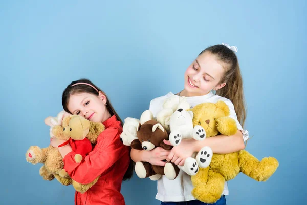 Charity sale. Love and friendship. Kids adorable cute girls play soft toys. Happy childhood. Child care. Sisters best friends play. Sweet childhood. Childhood concept. Softness and tenderness — Stock Photo, Image