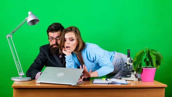 woman and man work in office at laptop. secretary with boss at workplace. business couple at computer. businessman and assistant solve problem. love affair at work. Seduction. Everyday winners