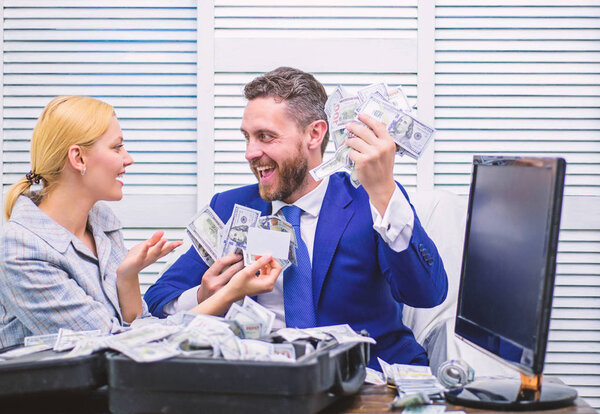 Smiling businessman with bundle of american dollar cash money at office. Happy businessman with heap of dollar money at office. Payday and payment concept