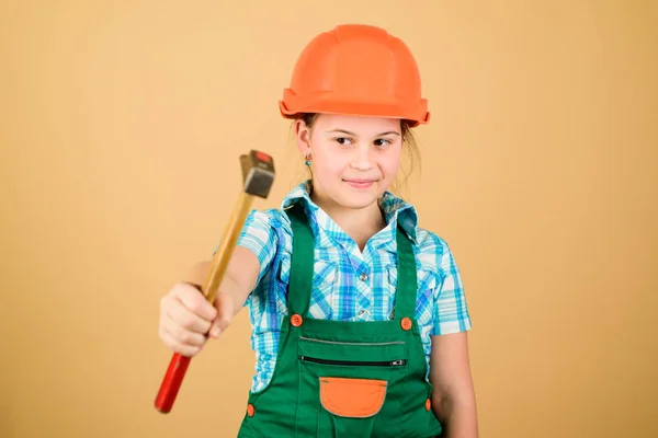 Labor day. 1 may. Foreman inspector. Repair. Safety expert. Future profession. small girl repairing in workshop. Little girl in helmet with hammer. Kid worker in hard hat. Working in repair shop