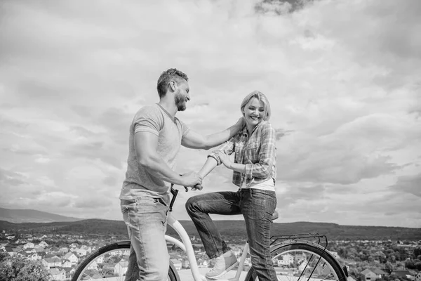 Man with beard and shy blonde lady on first date. How to meet girls while riding bike. Picking up girl. Couple just meet to become acquainted. Woman feels shy in company with attractive macho