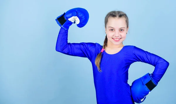 Be strong. punching knockout. Childhood. workout of small girl boxer. Sport success. sportswear fashion. Fitness diet. energy health. Happy child sportsman in boxing gloves. Strength and motivation