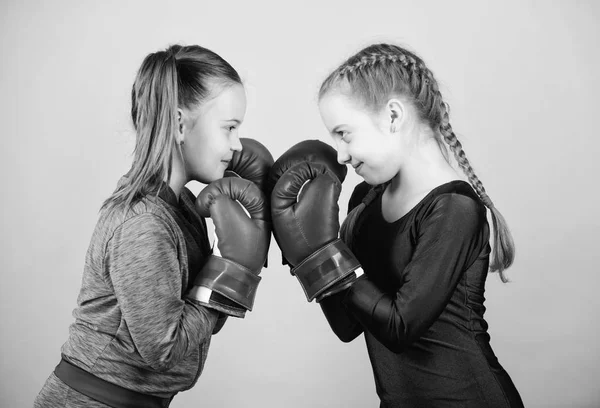 punching knockout. Childhood activity. Fitness diet. energy health. workout of small girls boxer in sportswear. Sport success. Friendship. Happy children sportsman in boxing gloves. Simply the best
