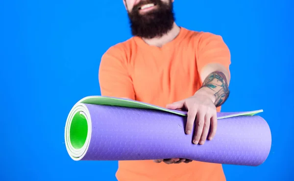 Yoga as hobby and sport. Practicing yoga every day. Man bearded athlete hold fitness mat. Fitness and stretching. Having good stretch. Athlete yoga coach motivated for training. Yoga class concept