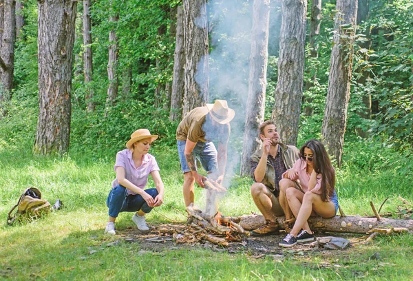 Company friends picnic or barbecue roasting food near bonfire. Hike barbecue. Best friends spend leisure weekend hike barbecue forest nature background. Friends enjoy weekend barbecue in forest — Stock Photo, Image