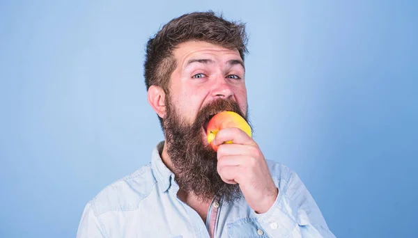 I love apples Man diet nutrition eats fruit. Healthy nutrition concept. Man handsome hipster with long beard eating apple. Hipster hungry bites juicy ripe apple. Fruit healthy snack always good idea