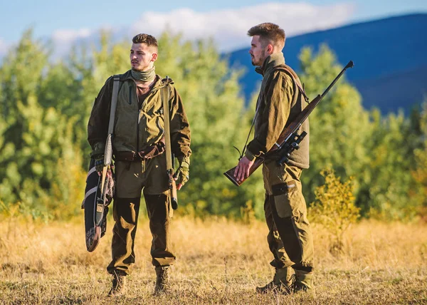 Gamekeepers walk mountains background. Gamekeepers sunny fall day. Gamekeeper occupation concept. Hunting with partner provide greater safety fun and rewarding. Gamekeeper rifles nature environment — Stock Photo, Image