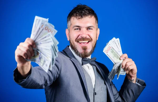 Investing to become rich. Business startup loan. Bearded man holding cash money. Making money with his own business. Currency broker with bundle of money. Rich businessman with us dollars banknotes