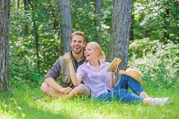 Couple in love spend leisure in park or forest. Romantic couple students enjoy leisure looking upwards observing nature background. Couple soulmates at romantic date. Romantic date at green meadow