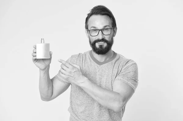 Amazing benefits of using perfumes. Man bearded handsome hold bottle perfume. How choose perfume for men according to occasion. Make sure smell fresh throughout day. Wearing perfume is enhancing mood
