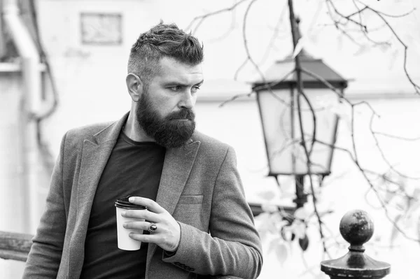 Relaxing coffee break. Hipster hold paper coffee cup and enjoy park environment. Drink it on the go. Man bearded hipster prefer coffee take away. Businessman bearded guy drink coffee outdoors — Stock Photo, Image
