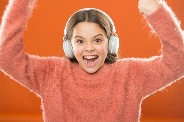 Music is her soul. Girl cute little child wear headphones listen music. Kid listen music orange background. Recommended music based on your initial interest. Radio app for your mobile device