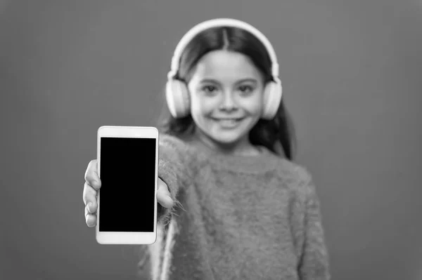 Best music apps for free. Listen for free. Get music account subscription. Access to millions songs. Enjoy music concept. Enjoy perfect sound. Girl child listen music modern headphones and smartphone — Stock Photo, Image