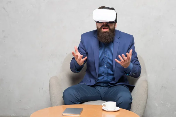 Businessman sit chair wear hmd explore virtual reality or ar. Business partner interact in virtual reality. New opportunity. Business implement modern technology. Virtual office and work space