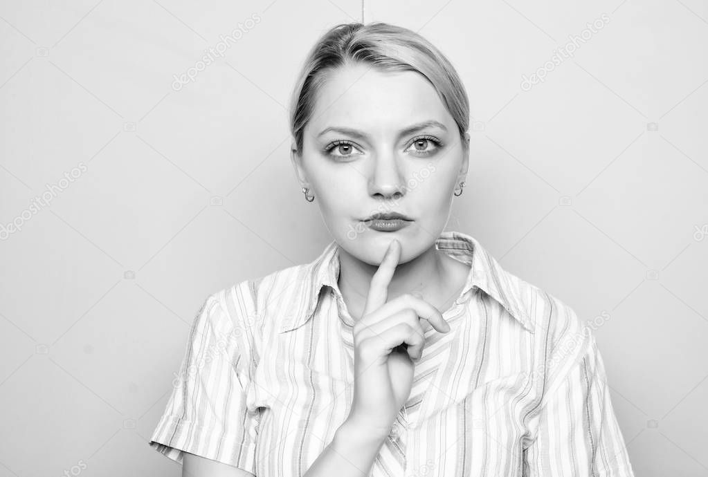 Woman concentrated face finger chin thinking. Need time to make decision. Come up with idea. Thinking about idea. Girl blonde thoughtful face expression close up. Ready to share idea concept