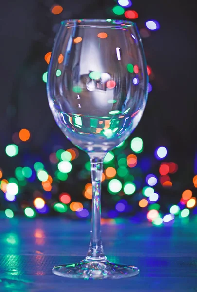 Cocktail ideas concept. Easy recipes for winter alcoholic cocktail drinks. Cocktail glass on defocused garland colorful lights. What to drink on christmas party. Alcohol cocktail for winter party