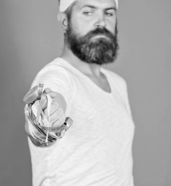 İnce yapılı aşağı çalışıyor. Kalori yanık sırasında ve fitness egzersiz sonrası. Kilo kaybı. Fitness ve sağlık. Adam sakallı fitness sporcu atlet tutun şerit metre. Eğitim atlet spor hocası