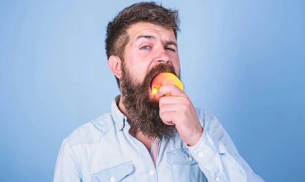 I love apples Man handsome hipster with long beard eating apple. Hipster hungry bites juicy ripe apple. Fruit healthy snack always good idea. Man diet nutrition eats fruit. Healthy nutrition concept