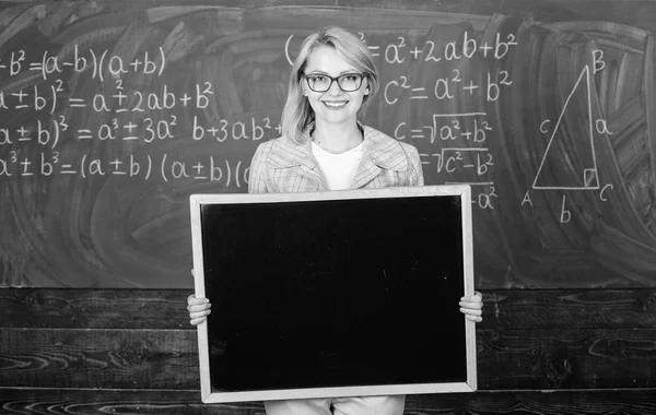 Teacher hold blackboard blank advertisement copy space. Information for incoming exchange students. Teacher show school advertisement. Place for school advertisement. Official advertisement concept — Stock Photo, Image
