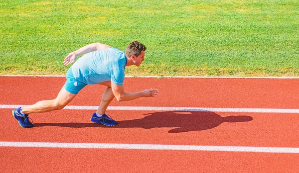 Boost speed concept. Man athlete runner push off starting position stadium path sunny day. Runner sprint race at stadium. Runner captured in motion just after start of race. How to start running — Stock Photo, Image