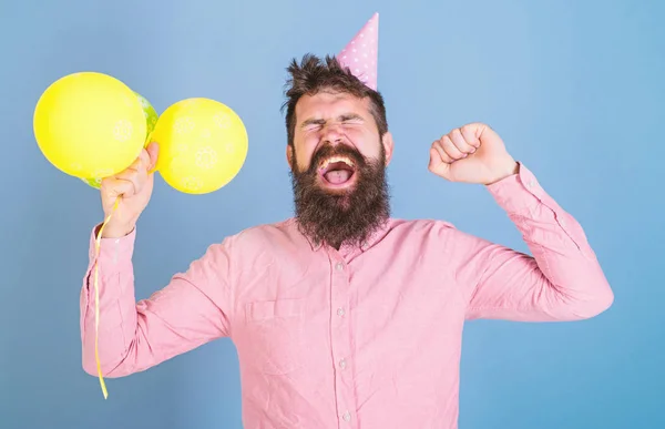 Man in paper cap isolated on blue background. Daddy exhausted after day with kids, International children day celebration. Hipster with trendy beard yawning. Bearded man tired after birthday party — Stock Photo, Image