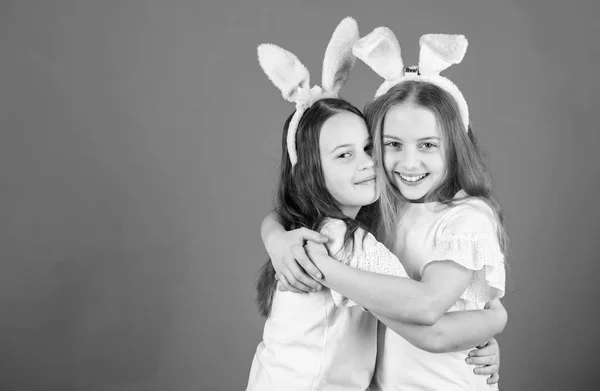 Kinderen easter bunny kostuum. Speelse meisjes zusters vieren Pasen. Voorjaar vakantie. Gelukkige jeugd. Vriendschap concept. Pasen vibes. Vrolijk Pasen. Vakantie bunny meisjes met lange bunny oren knuffel — Stockfoto