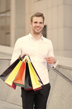 Adam resmi kıyafet alışveriş torbaları taşımak. Adam mutlu taşımak grup alışveriş torbaları. Karlı fırsatlar siyah Cuma. Bir dakika dostum çok kağıt çanta paketleri alışveriş merkezinde alışveriş sonra. Siyah Cuma satış konsepti