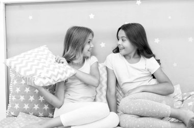 Eğlenmek için akşam vakti. Pijama partisi fikirleri. Kızlar mutlu en iyi arkadaşlar ya da güzel pijamalı kardeşler ve yastıklı pijama partisi. Kız kardeşler pijama partisinde eğleniyor. Yastık savaşı pijama partisi