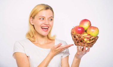 Woman know how stay in shape and be healthy. Take advantage of this fall produce and bite into juicy apple. Girl hold basket apples white background. Metabolism and dieting. Healthy nutrition concept clipart