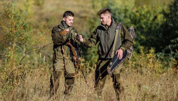 Hunters friends enjoy leisure. Poacher partner in crime. Activity for real men concept. Hunters gamekeepers looking for animal or bird. Hunters with rifles in nature environment. Illegal hunting — Stock Photo, Image