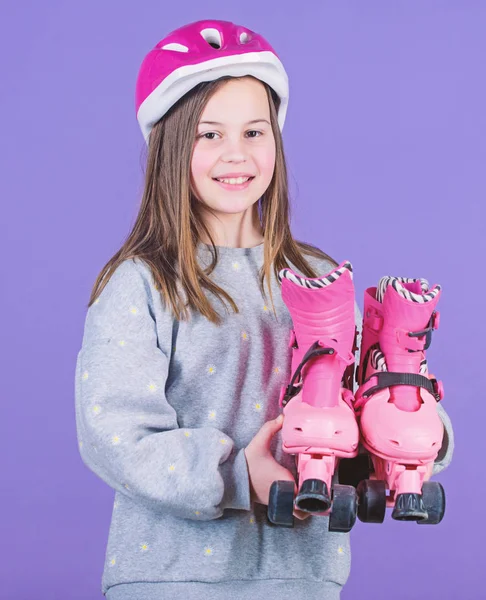 Happy child with roller skates. Little girl has roller skates. Fitness health and energy. race workout of teen girl. Roller skating. Freestyle. Sport success. Sincere fun. roller skates for kid