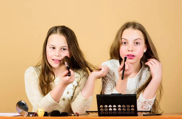 Children little girls choose cosmetics. Makeup store. Experimenting with style. Makeup art. Explore cosmetics bag concept. Salon and beauty treatment. Just like playing with makeup. Makeup courses