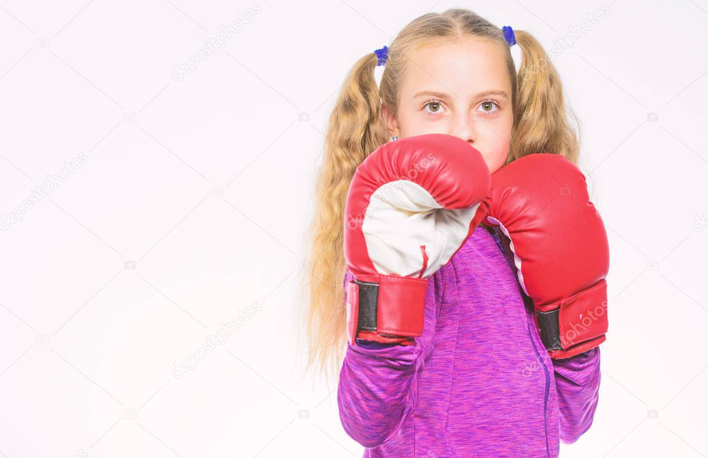 Feminist movement. Self defence concept. Girl boxer knows how defend herself. Girl child strong with boxing gloves posing on white background. She ready to defend herself. Sport upbringing for girls