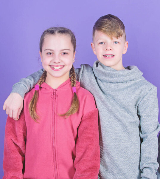 Teens friends. Girl and boy true friendship. Children smiling faces on violet background. Friends hug. Childrens day. Cheerful youth. Relations and friendship. Happy to have such good friends