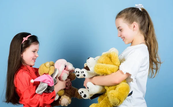 Toy shop. childrens day. small girls with soft bear toys. happy childhood. handmade. sewing and diy crafts. playground in kindergarten. little sisters girls playing game in playroom. Playful girls — Stock Photo, Image