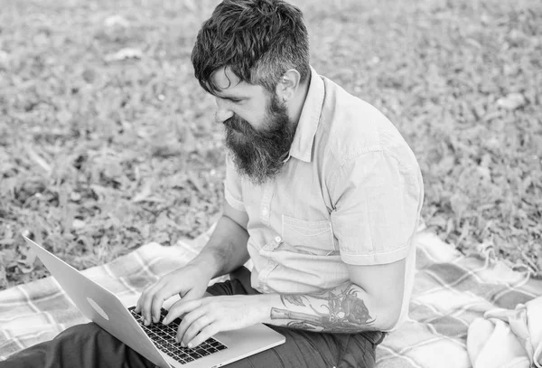Hipster blogger with laptop nature background. Blogger create content for social network. Writer or blogger write post for social network. Creativity crisis. Blogger thoughtful face create content