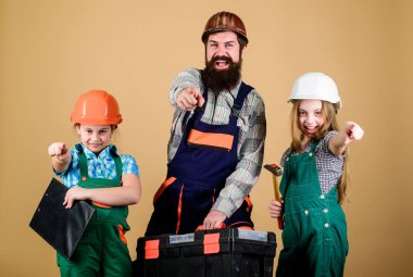 Küçük kızlarla sakallı bir adam. Baba ve kızı atölyede. Üniformalı tamirci. Foreman. inşaat işçisi asistanı. İnşaatçı ya da marangoz. Aile takım çalışması. Onarım. Hemen başlamaya hazır