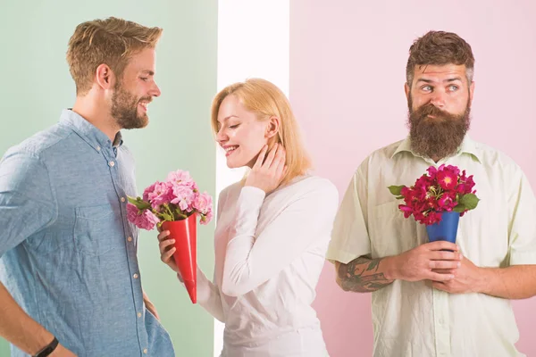 Men competitors with bouquets flowers try conquer girl. Broken heart concept. Girl smiling made her choice. Girl popular receive lot male attention. Woman happy takes bouquet flowers romantic gift — Stock Photo, Image