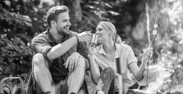 Weekend picnic. Food for hike and camping. Couple sit near bonfire eat snacks and drink. Couple take break to eat nature background. Couple in love camping forest hike. Hike snacks and beverages — Stock Photo, Image