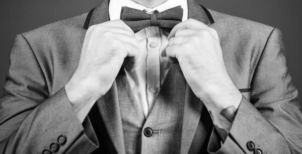 esthete. stylish art director. businessman fix bow tie. illusionist. Bride groom ready for wedding. business man in formal suit. PR manager make his style. Tying a bow tie. Close-up on nerd
