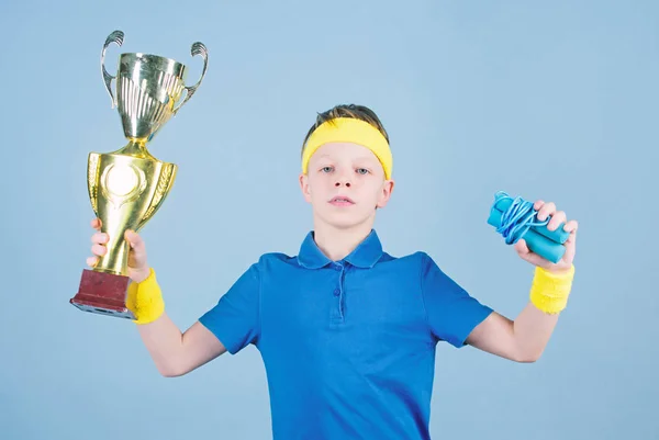 Happy child sportsman hold champion cup trophy. Fitness and diet. Energy. Gym workout of teen boy winner. Success trophy. Childhood activity. Sport and health. Winner with his trophy. Pure perfection